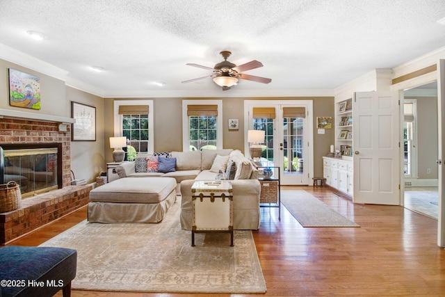 3509 Lakeview Trl, Kinston, NC 28504 - living room featuring a textured ceiling, ornamental molding, wood finished floors, ceiling fan, and french doors