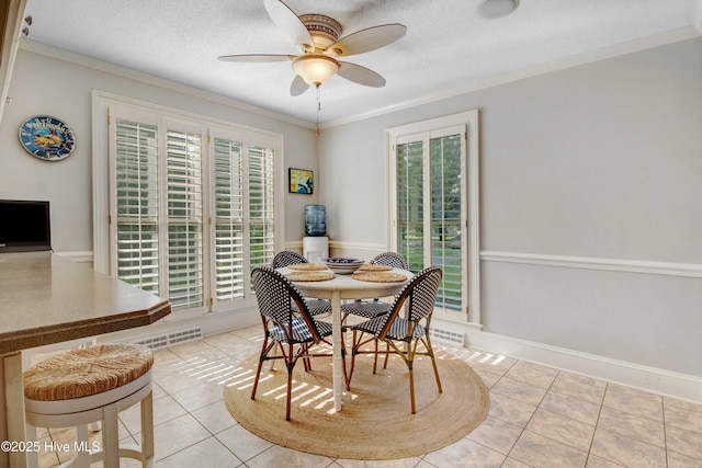 3509 Lakeview Trl, Kinston, NC 28504 - dining room featuring light tile patterned floors, ceiling fan, plenty of natural light, ornamental molding, and a textured ceiling