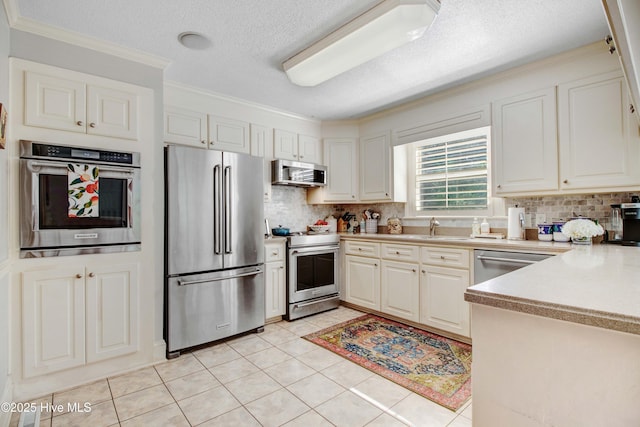 3509 Lakeview Trl, Kinston, NC 28504 - kitchen featuring appliances with stainless steel finishes, tasteful backsplash, crown molding, light countertops, and light tile patterned floors