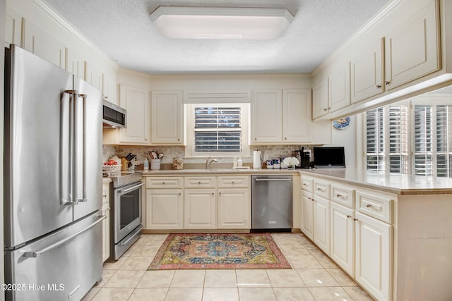 3509 Lakeview Trl, Kinston, NC 28504 - kitchen with stainless steel appliances, tasteful backsplash, light countertops, light tile patterned floors, and a textured ceiling