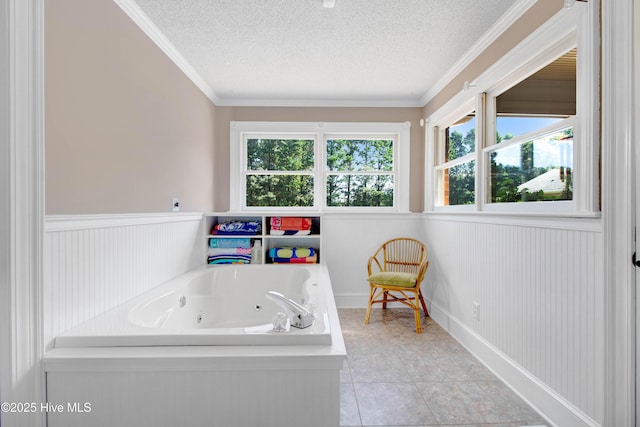 3509 Lakeview Trl, Kinston, NC 28504 - full bath featuring a tub with jets, a textured ceiling, wainscoting, ornamental molding, and tile patterned floors