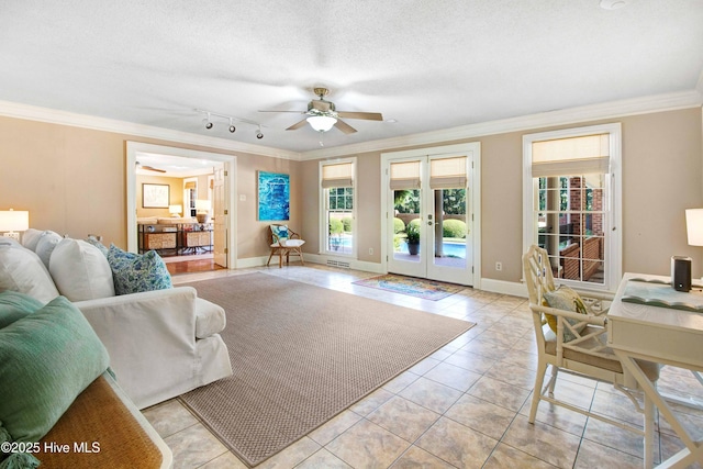 3509 Lakeview Trl, Kinston, NC 28504 - living room featuring ornamental molding, ceiling fan, french doors, light tile patterned floors, and rail lighting