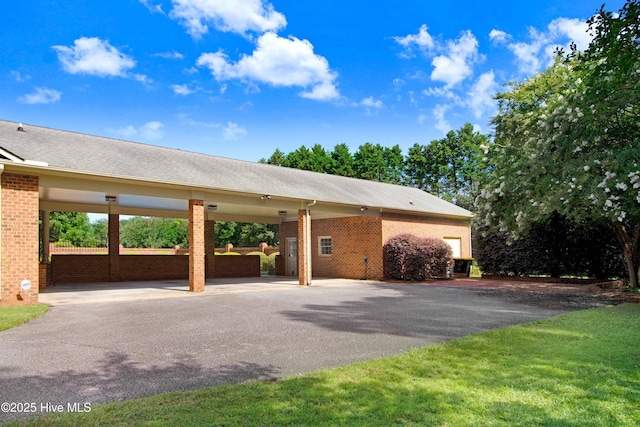 3509 Lakeview Trl, Kinston, NC 28504 - exterior space with brick siding, asphalt driveway, and a carport