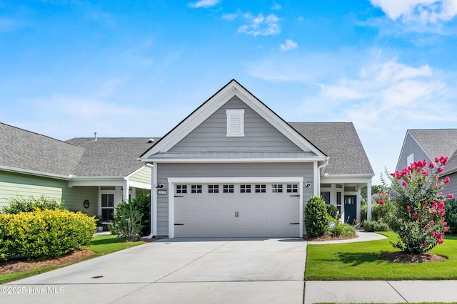 1105 Snowden Rd, Wilmington, NC 28412 - view of front of home featuring an attached garage, concrete driveway, and a front lawn