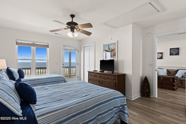 533 Ocean Blvd W, Holden Beach, NC 28462 - bedroom with attic access, access to exterior, wood finished floors, and ceiling fan
