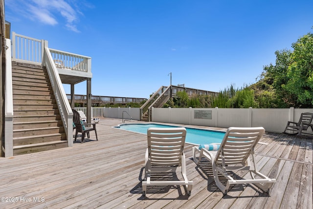 533 Ocean Blvd W, Holden Beach, NC 28462 - view of swimming pool featuring stairway, a wooden deck, and a fenced backyard
