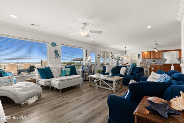 533 Ocean Blvd W, Holden Beach, NC 28462 - living area with light wood-style floors, ceiling fan, ornamental molding, a chandelier, and recessed lighting