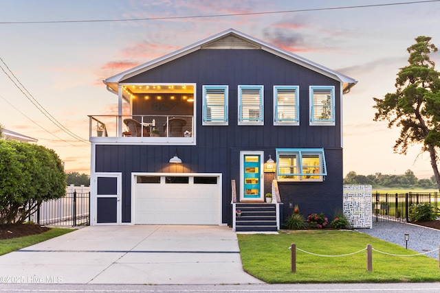 15 Coral Dr, Wrightsville Beach, NC 28480 - view of front facade with a balcony, driveway, and an attached garage