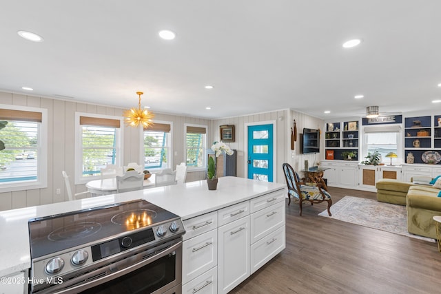 15 Coral Dr, Wrightsville Beach, NC 28480 - kitchen with stainless steel electric stove, open floor plan, white cabinets, light countertops, and dark wood-style floors