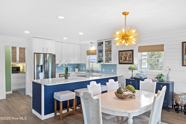 15 Coral Dr, Wrightsville Beach, NC 28480 - dining room with a chandelier, wood finished floors, ornamental molding, and recessed lighting