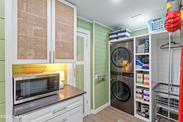 15 Coral Dr, Wrightsville Beach, NC 28480 - washroom featuring stacked washer / drying machine, light wood-style flooring, and crown molding