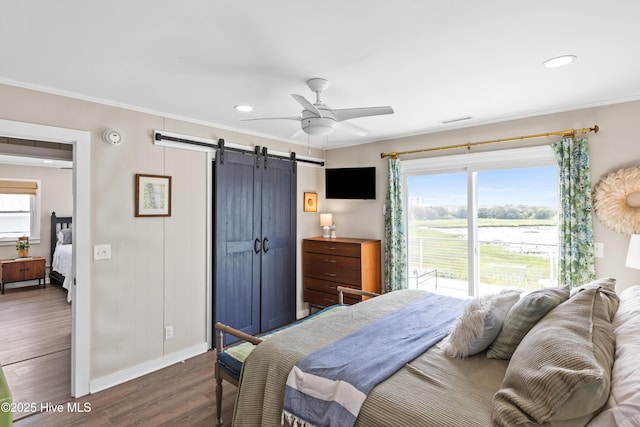 15 Coral Dr, Wrightsville Beach, NC 28480 - bedroom with a barn door, dark wood-type flooring, crown molding, multiple windows, and recessed lighting