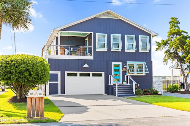15 Coral Dr, Wrightsville Beach, NC 28480 - view of front of house featuring a balcony, a garage, and driveway