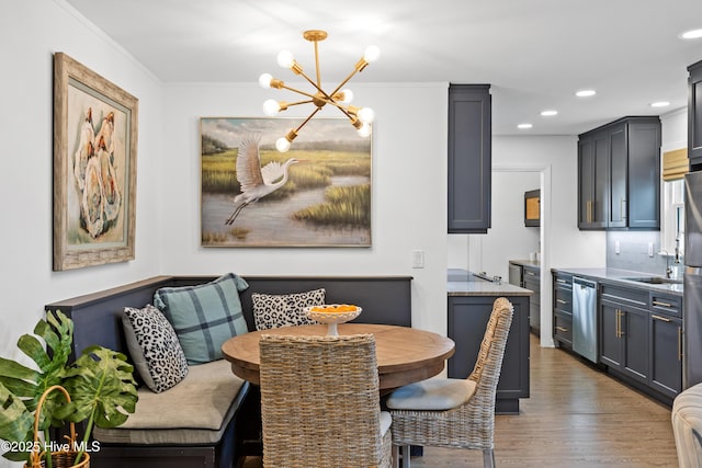 15 Coral Dr, Wrightsville Beach, NC 28480 - dining room featuring a chandelier, wood finished floors, breakfast area, recessed lighting, and crown molding