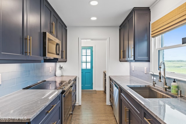 15 Coral Dr, Wrightsville Beach, NC 28480 - kitchen featuring stainless steel appliances, healthy amount of natural light, light wood-style floors, recessed lighting, and backsplash