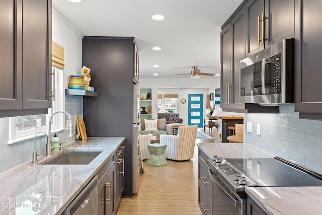 15 Coral Dr, Wrightsville Beach, NC 28480 - kitchen featuring stainless steel appliances, backsplash, light stone countertops, open shelves, and recessed lighting