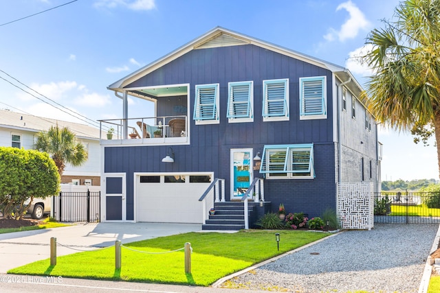 15 Coral Dr, Wrightsville Beach, NC 28480 - view of front facade featuring a balcony, concrete driveway, and a garage