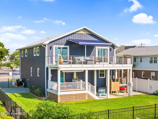 15 Coral Dr, Wrightsville Beach, NC 28480 - back of property featuring a balcony, a fenced backyard, a patio area, and cooling unit