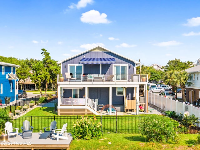 15 Coral Dr, Wrightsville Beach, NC 28480 - back of house with a balcony, a fenced backyard, and stairs
