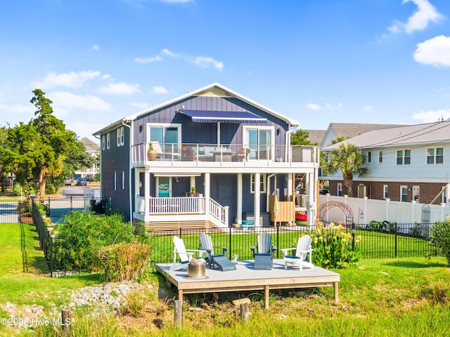 15 Coral Dr, Wrightsville Beach, NC 28480 - back of property featuring a balcony, a fenced backyard, and a deck
