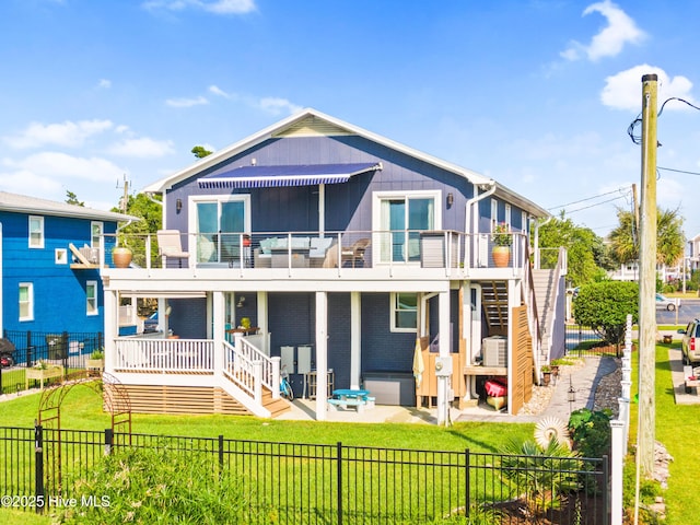 15 Coral Dr, Wrightsville Beach, NC 28480 - rear view of property with a fenced backyard, stairway, a balcony, and a patio area
