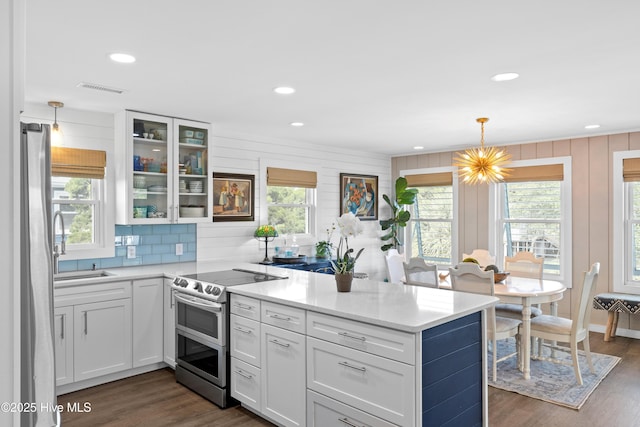 15 Coral Dr, Wrightsville Beach, NC 28480 - kitchen with electric range, a peninsula, healthy amount of natural light, freestanding refrigerator, and recessed lighting