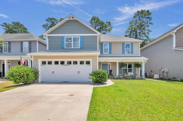 3239 Kellerton Pl, Wilmington, NC 28409 - view of front facade featuring concrete driveway, a front yard, a garage, covered porch, and roof with shingles