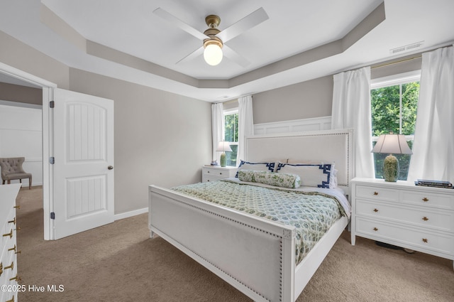 3239 Kellerton Pl, Wilmington, NC 28409 - bedroom with light carpet, a tray ceiling, and ceiling fan