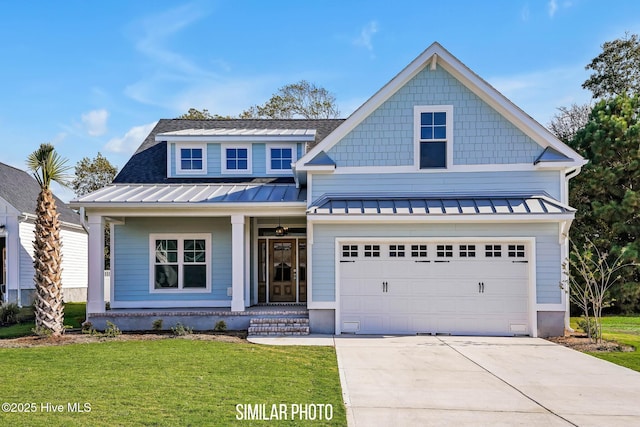 606 Martin House Loop, Holly Ridge, NC 28445 - view of front of property featuring a standing seam roof, a front yard, concrete driveway, a shingled roof, and a metal roof