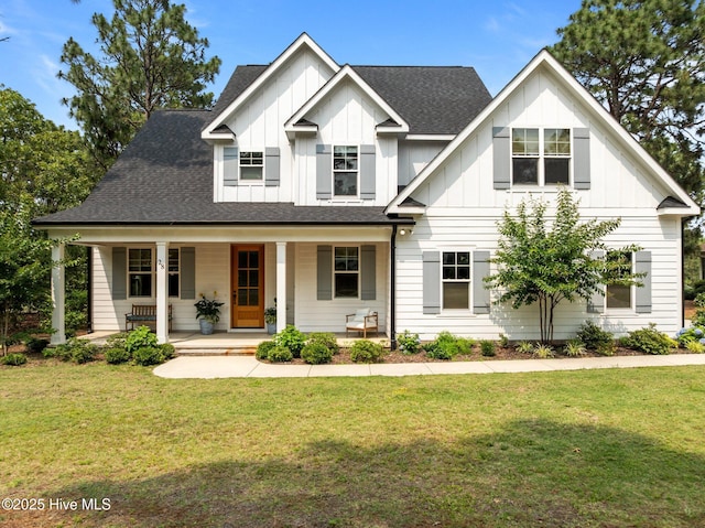 28 Kahkwa Trl, Pinehurst, NC 28374 - view of front of house with board and batten siding, a front yard, covered porch, and roof with shingles