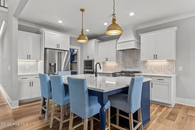 28 Kahkwa Trl, Pinehurst, NC 28374 - kitchen featuring custom exhaust hood, appliances with stainless steel finishes, a kitchen bar, tasteful backsplash, and crown molding