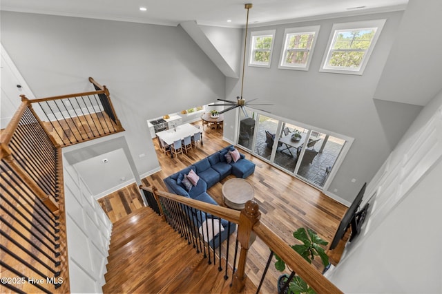 28 Kahkwa Trl, Pinehurst, NC 28374 - stairway with wood finished floors, ornamental molding, recessed lighting, a ceiling fan, and a high ceiling
