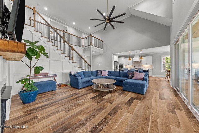 28 Kahkwa Trl, Pinehurst, NC 28374 - living room with a towering ceiling, ceiling fan, light wood-style flooring, stairs, and recessed lighting