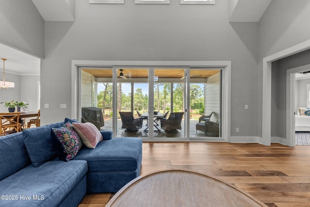 28 Kahkwa Trl, Pinehurst, NC 28374 - living area with a high ceiling, wood finished floors, healthy amount of natural light, a chandelier, and ceiling fan