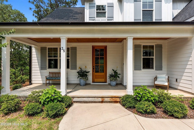 28 Kahkwa Trl, Pinehurst, NC 28374 - doorway to property featuring a porch and a shingled roof
