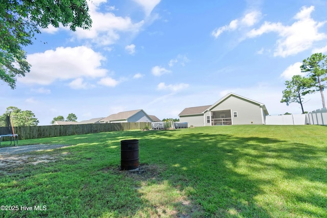 106 Rolling Knoll Ct, Dudley, NC 28333 - fenced backyard with a trampoline and a sunroom