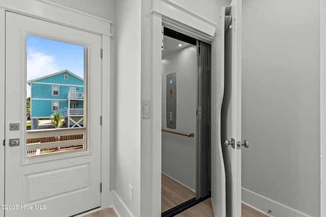 207 Spartanburg Ave Unit 1 & 2, Carolina Beach, NC 28428 - doorway to outside with wood finished floors and baseboards