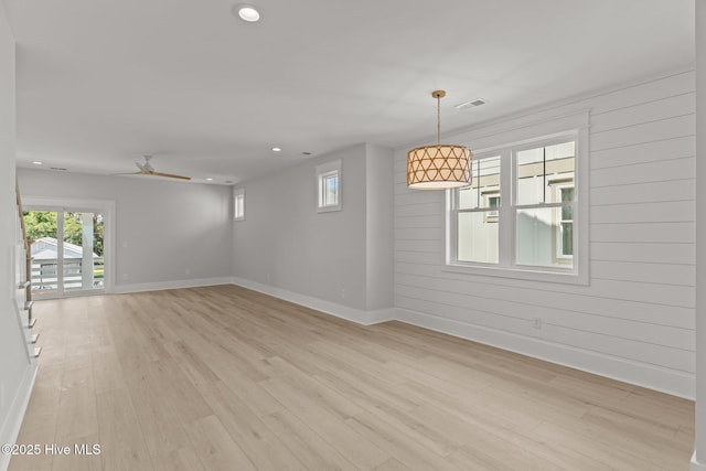 207 Spartanburg Ave Unit 1 & 2, Carolina Beach, NC 28428 - unfurnished room with light wood finished floors, recessed lighting, ceiling fan, and wooden walls