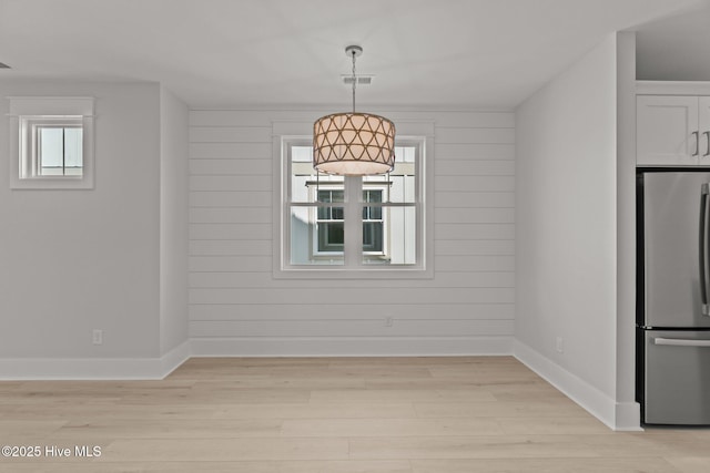 207 Spartanburg Ave Unit 1 & 2, Carolina Beach, NC 28428 - unfurnished dining area featuring light wood finished floors and wooden walls
