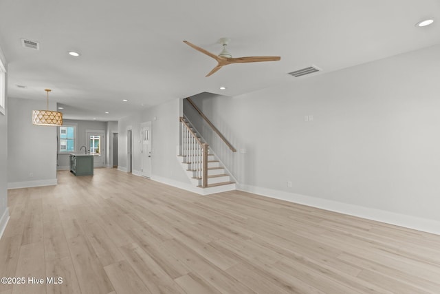 207 Spartanburg Ave Unit 1 & 2, Carolina Beach, NC 28428 - unfurnished living room featuring recessed lighting, light wood finished floors, stairway, and ceiling fan