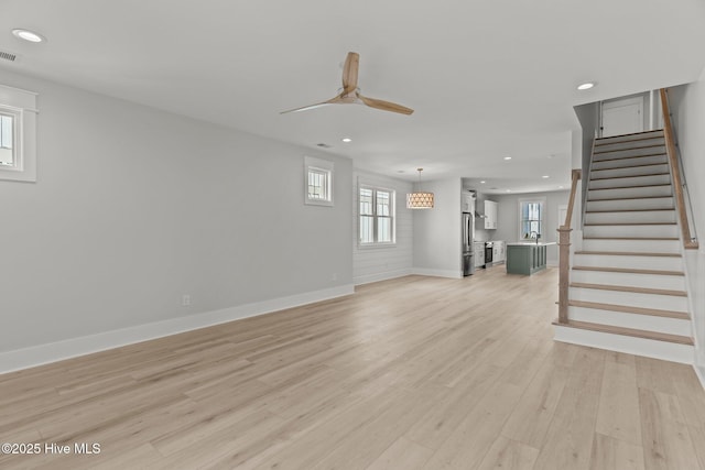 207 Spartanburg Ave Unit 1 & 2, Carolina Beach, NC 28428 - unfurnished living room with recessed lighting, light wood-style floors, stairway, and a ceiling fan