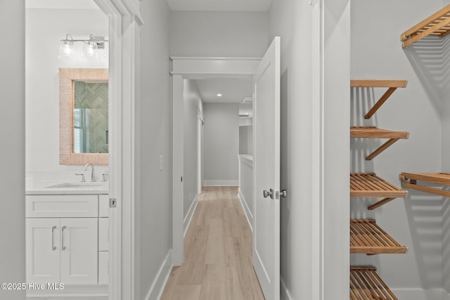 207 Spartanburg Ave Unit 1 & 2, Carolina Beach, NC 28428 - hallway featuring a sink and light wood-type flooring