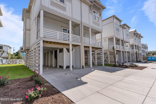 207 Spartanburg Ave Unit 1 & 2, Carolina Beach, NC 28428 - back of house featuring a carport and driveway