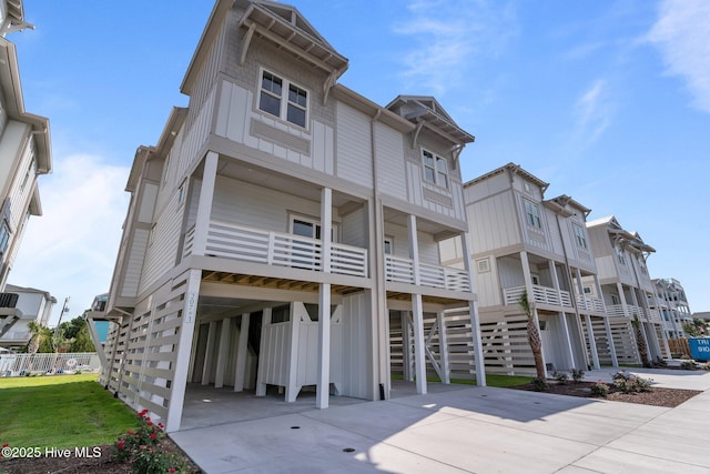 207 Spartanburg Ave Unit 1 & 2, Carolina Beach, NC 28428 - view of front of house featuring a carport and concrete driveway