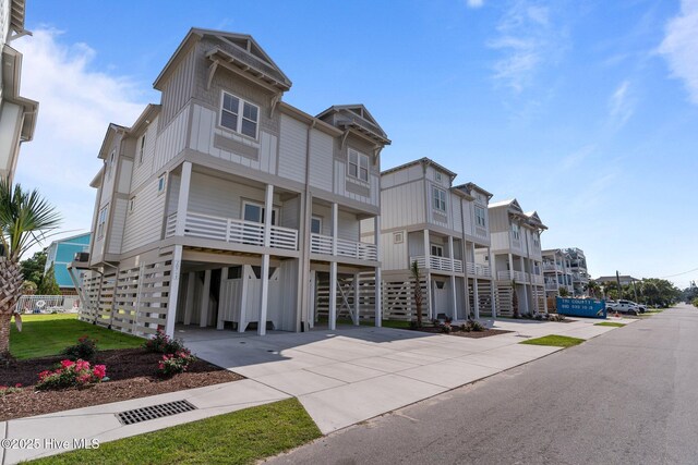 207 Spartanburg Ave Unit 1 & 2, Carolina Beach, NC 28428 - view of front of home with a carport, concrete driveway, and board and batten siding