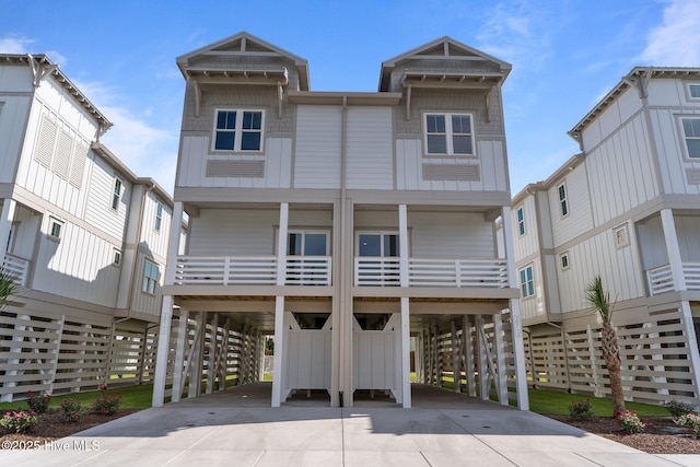 207 Spartanburg Ave Unit 1 & 2, Carolina Beach, NC 28428 - coastal inspired home featuring a carport and concrete driveway