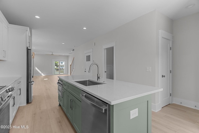 207 Spartanburg Ave Unit 1 & 2, Carolina Beach, NC 28428 - kitchen with green cabinetry, appliances with stainless steel finishes, light wood-style flooring, white cabinets, and recessed lighting