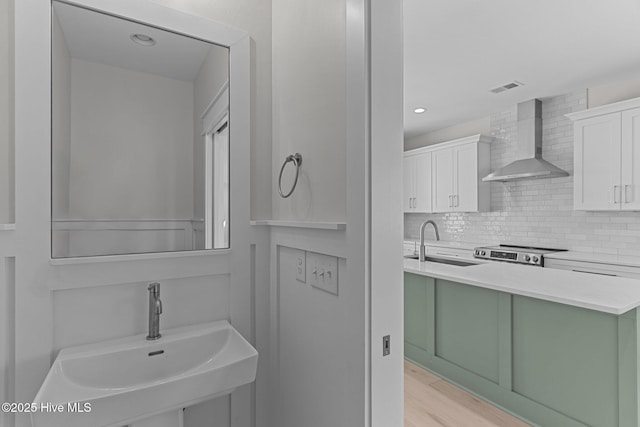 207 Spartanburg Ave Unit 1 & 2, Carolina Beach, NC 28428 - bathroom with tasteful backsplash, wood finished floors, and recessed lighting