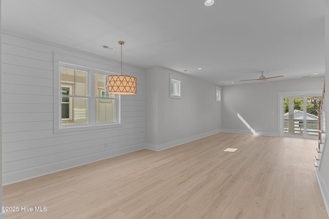207 Spartanburg Ave Unit 1 & 2, Carolina Beach, NC 28428 - unfurnished living room with light wood-type flooring, ceiling fan, wood walls, and recessed lighting