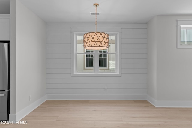 207 Spartanburg Ave Unit 1 & 2, Carolina Beach, NC 28428 - unfurnished dining area with light wood finished floors and wooden walls